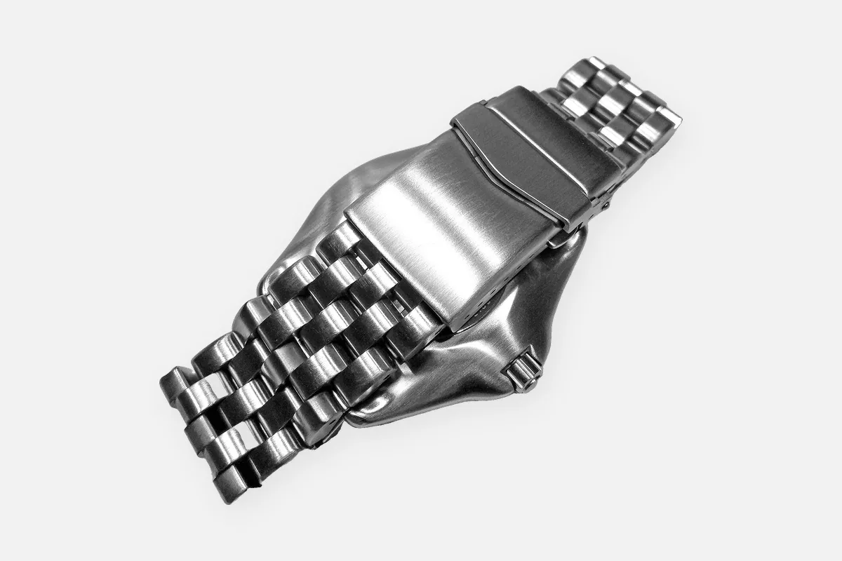 Fold-over clasp on a stainless steel watch bracelet